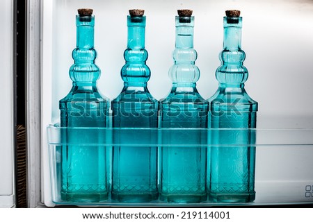 Water bottle placed in the refrigerator.blue water bottle arrange in rainbow color, isolated on white