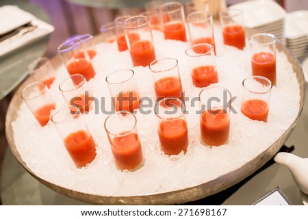 canapes on toothpicks , appetizer, pinchos , spanish food ,delicious finger food,tomato juice glass isolated on ice