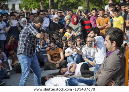 ISTANBUL/TURKEY - MAY 18 2014: Syrian Demonstrators perform short sketch that illustrates Bashar Al-Assad's attachment to the presidency, and how far he will go to keep it.