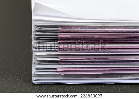 closeup ,a file folder with documents and documents. retention of contracts.