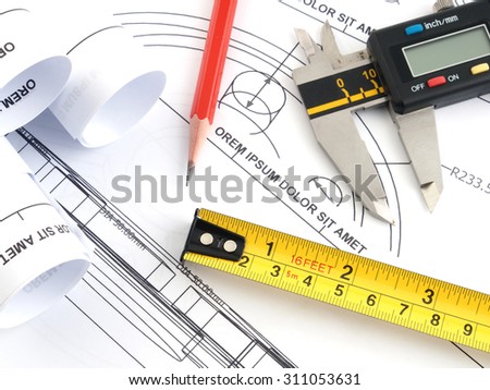 pencil and measuring tape and vernier caliper on plans