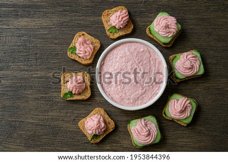 Different toasts with tarama around a white bowl with taramasalata on a dark wooden table, top view Stok fotoğraf © 