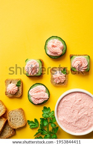 A bowl with tarama and crostini or taramasalata canape on the yellow background, top view with copy space Stok fotoğraf © 