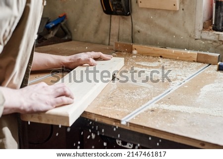 Similar – Image, Stock Photo Unrecognizable handyman using machine on factory