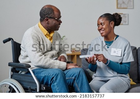 Similar – Image, Stock Photo Home caregiver helping senior woman with medication