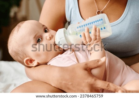 Similar – Image, Stock Photo Mother bottle feeding newborn