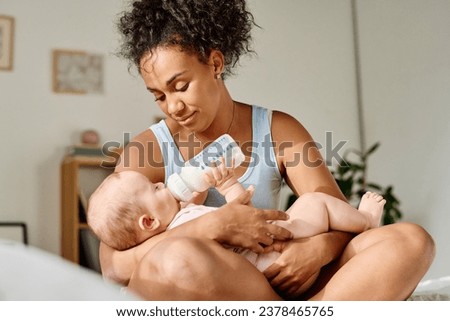 Similar – Image, Stock Photo Mother bottle feeding newborn