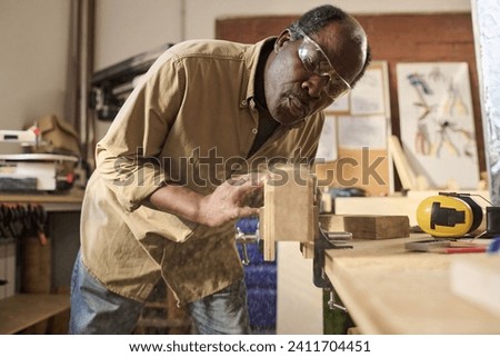 Similar – Image, Stock Photo Senior male woodworker working in garage