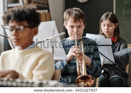 Similar – Image, Stock Photo Serious boy playing on smartphone