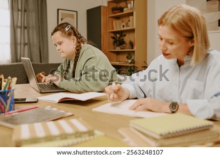 Similar – Image, Stock Photo Mother checking on her children who is riding in the front section of a cargo bike