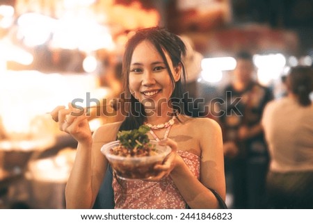 Similar – Image, Stock Photo Woman eating grilled squid skewer in restaurant