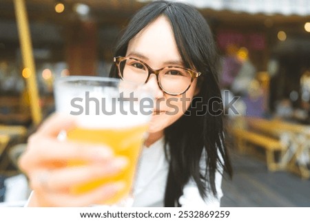 Similar – Image, Stock Photo Young woman drinking beer in a beach bar