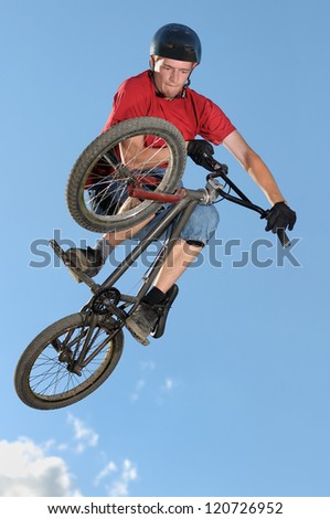Bmx rider making a bike jump called table top