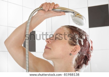 woman rinsing shampoo after hair wash in the shower