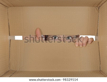 Curious person peering in a cardboard box