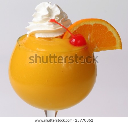Frozen drink garnished with fruit and whipped cream.