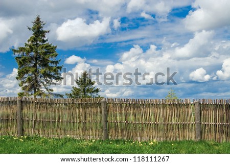 Rural landscape with countryside yard and fence