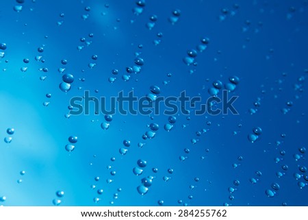Blue water drops on mirror background