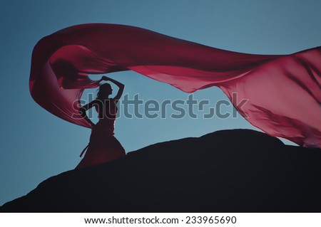 Lady wind - yang woman in red dress on a rock with flowing fabric 08