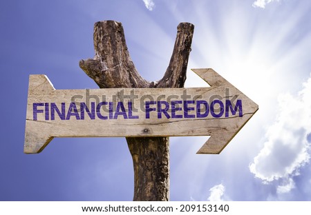 Financial Freedom wooden sign on a beautiful day