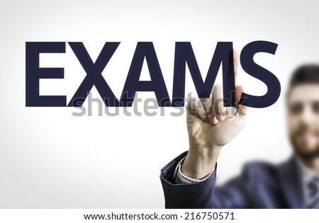 Business man pointing to transparent board with text: Exams