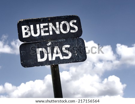 Good Morning (In Spanish) sign with clouds and sky background