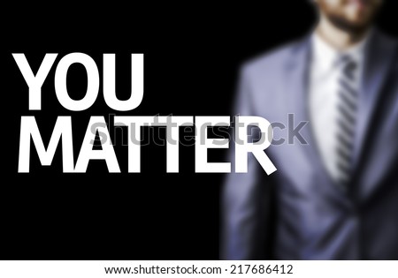 You Matter written on a board with a business man on background