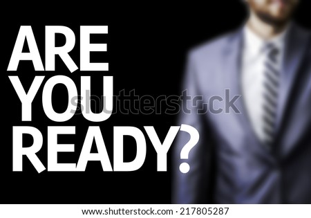 Are You Ready? written on a board with a business man on background