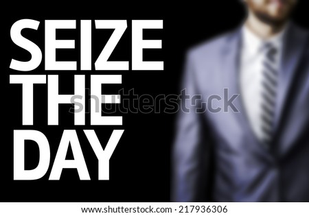 Seize The Day written on a board with a business man on background