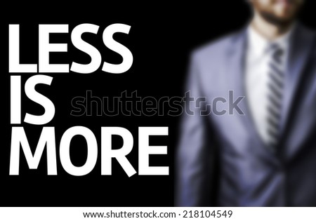 Less is More written on a board with a business man on background