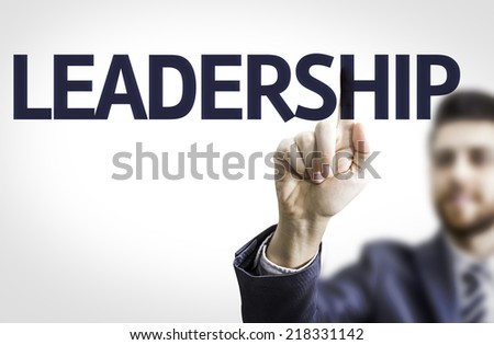 Business man pointing to transparent board with text: Leadership