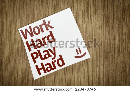 Work Hard Play Hard on Paper Note with texture background