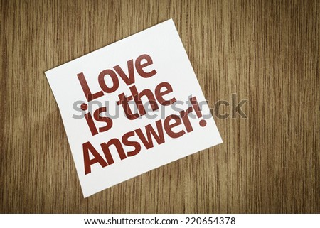 Love is the Answer! on Paper Note on texture background