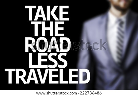 Business man with the text Take the Road Less Traveled in a concept image