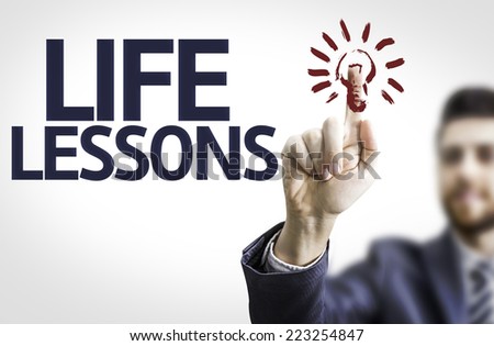 Business man pointing to transparent board with text: Life Lessons