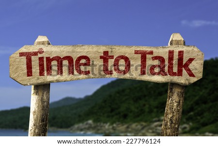 Time to Talk wooden sign with a beach on background