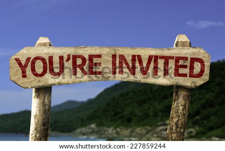 You\'re Invited wooden sign with a beach on background