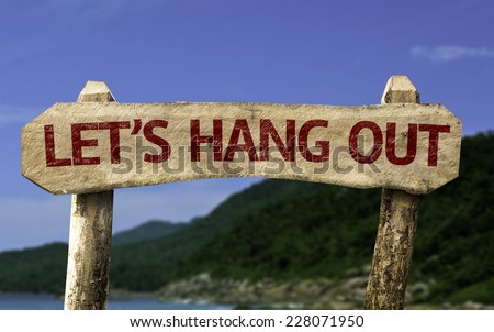 Let\'s Hang Out wooden sign with a beach on background
