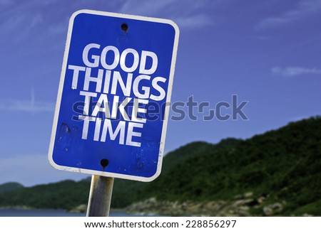 Good Things Take Time sign with a beach on background