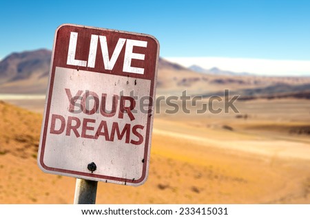 Live Your Dreams sign with a desert background