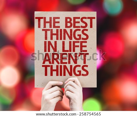 The Best Things in Life Aren\'t Things card with colorful background with defocused lights