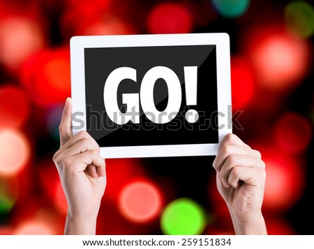 Tablet pc with text GO! with bokeh background