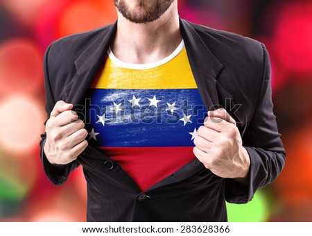 Businessman stretching suit with Venezuela flag on bokeh background