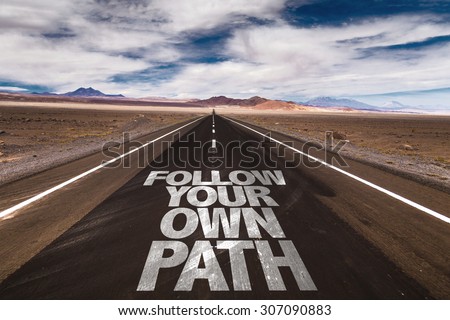 Follow Your Own Path written on desert road