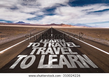 Learn to Travel Travel to Learn written on desert road