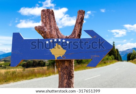 Kosovo Flag wooden sign with road background