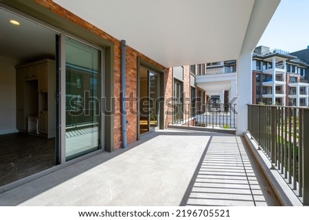 Similar – Image, Stock Photo An empty balcony and a closed shutter above it, plus a railing that no longer protects anyone