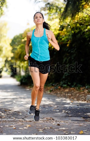 running healthy fitness woman training for marathon outdoors in alleyway. vitality lifestyle run