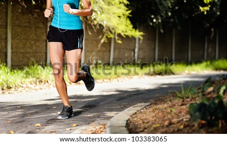 running healthy fitness woman training for marathon outdoors in alleyway. vitality lifestyle run