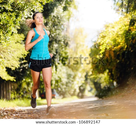 running healthy fitness woman training for marathon outdoors in alleyway. vitality lifestyle exercise athlete.